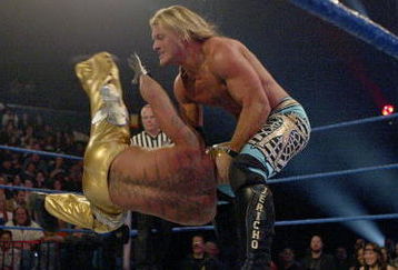 LAS VEGAS - DECEMBER 2:  (U.S. TABLOIDS OUT)   WWE wrestlers Rey Mysterio (in gold) and Chris Jericho perform on stage during the '1st Annual Video Game Awards' at the MGM Grand Garden Arena December 2, 2003 in Las Vegas, Nevada.  The show premieres on Spike T.V. Thursday, December 4 at 9:00PM ET/PT.  (Photo by Frank Micelotta/Getty Images)