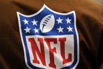 HOUSTON - OCTOBER 19:  An NFL Films photographer wears a brown vest with the NFL shield logo during play against the Detroit Lions and the Houston Texans at Reliant Stadium on October 19, 2008 in Houston, Texas.  (Photo by Ronald Martinez/Getty Images)