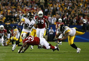 TAMPA, FL - FEBRUARY 01:  James Harrison #92 of the Pittsburgh Steelers runs back an interception for 100 yards to score a touchdown in the second quarter against Tim Hightower #34 of the Arizona Cardinals during Super Bowl XLIII on February 1, 2009 at Raymond James Stadium in Tampa, Florida.  (Photo by Al Bello/Getty Images)