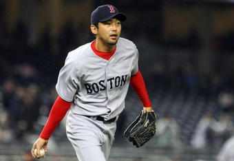 NEW YORK - MAY 05:  Takashi Saito #24 of the Boston Red Sox flips the ball to first base for an out against the New York Yankees on May 5, 2009 at Yankee Stadium in the Bronx borough of New York City. The Red Sox defeated the Yankees 7-3.  (Photo by Jim McIsaac/Getty Images)