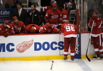 DETROIT - JUNE 12:  Brad Stuart #23, second from left, and Nicklas Lidstrom #5 of the Detroit Red Wings look on dejectedly after Game Seven of the 2009 NHL Stanley Cup Finals against the Pittsburgh Penguins at Joe Louis Arena on June 12, 2009 in Detroit, Michigan. The Penguins defeated the Red Wings 2-1 in the seventh game to win the Stanley Cup Finals series 4 games to 3. (Photo by Harry How/Getty Images)