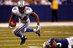 INDIANAPOLIS - DECEMBER 14:  Kevin Smith #34 of the Detroit Lions avoids a tackle by Tim Jennings #23 of the Indianapolis Colts on December 14, 2008 at Lucas Oil Stadium in Indianapolis, Indiana.  The Colts defeated the Lions 31-21.  (Photo by Chris Graythen/Getty Images)