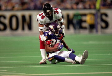 17 Jan 1999:  Randy Moss #84 of the Minnesota Vikings is being tackled by Ray Buchanan #34 after he caught the football during the NFC Championship Game against the Atlanta Falcons at the HHH Metrodome in Minneapolis, Minnesota. The Falcons defeated the Vikings 30-27. Mandatory Credit: Andy Lyons  /Allsport
