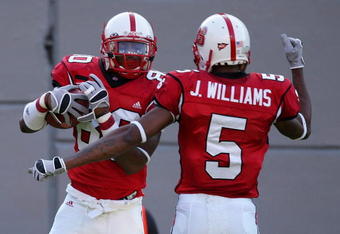 RALEIGH, NC - OCTOBER 27:  Teammates Jarvis Williams #5 and Donald Bowens #80 of the North Carolina State Wolfpack celebrate after Bowens' touchdown against the Virginia Cavaliers during their game at Carter-Finley Stadium October 27, 2007 in Raleigh, North Carolina.  (Photo by Streeter Lecka/Getty Images)