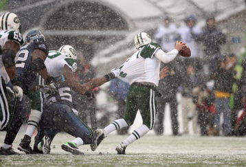 SEATTLE - DECEMBER 21:  Quarterback Brett Favre #4 of the New York Jets is grabbed by Darryl Tapp #55 of the Seattle Seahawks on December 21, 2008 at Qwest Field in Seattle, Washington. The Seahawks defeated the Jets 13-3. (Photo by Otto Greule Jr/Getty Images)
