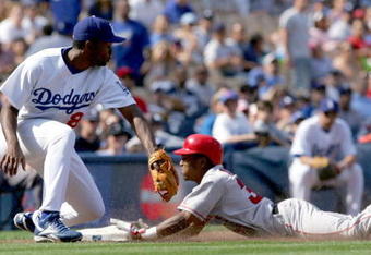 LOS ANGELES - APRIL 3:  Erick Aybar #32 of the Los Angeles Angels of Anaheim slides safely into third base in the ninth inning against the Los Angeles Dodger during an exhibition game on April 3, 2004 at Dodger Stadium in Los Angeles, California. The Angels defeated the Dodgers 6-4.  (Photo by Lisa Blumenfeld/Getty Images)