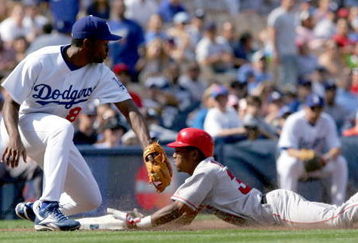 LOS ANGELES - APRIL 3:  Erick Aybar #32 of the Los Angeles Angels of Anaheim slides safely into third base in the ninth inning against the Los Angeles Dodger during an exhibition game on April 3, 2004 at Dodger Stadium in Los Angeles, California. The Angels defeated the Dodgers 6-4.  (Photo by Lisa Blumenfeld/Getty Images)