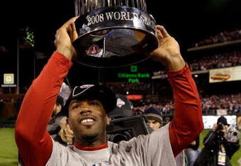 PHILADELPHIA - OCTOBER 29:  Jimmy Rollins #11 of the Philadelphia Phillies celebrates with the World Series Championship trophy after their 4-3 win against the Tampa Bay Rays during the continuation of game five of the 2008 MLB World Series on October 29, 2008 at Citizens Bank Park in Philadelphia, Pennsylvania.  (Photo by Pool/Getty Images)