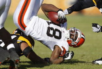 PITTSBURGH - DECEMBER 28: Donte Stallworth #18 of the Cleveland Browns is tackled after a first quarter catch by Tyrone Carter #23 and Andre Frazier #54 of the Pittsburgh Steelers at Heinz Field December 28, 2008 in Pittsburgh, Pennsylvania. (Photo by Gregory Shamus/Getty Images)