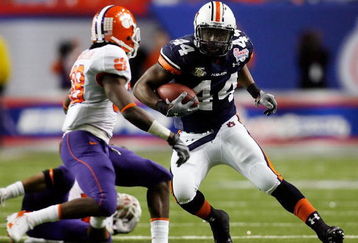 ATLANTA - DECEMBER 31:  Ben Tate #44 of the Auburn University Tigers runs against Chris Chancellor #38 of the Clemson University Tigers during the Chick-Fil-A Bowl on December 31, 2007 at the Georgia Dome in Atlanta, Georgia.  (Photo by Chris Graythen/Getty Images)