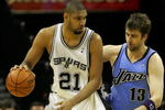 SAN ANTONIO - MAY 20:  Tim Duncan #21 of the San Antonio Spurs posts up Mehmet Okur #13 of the Utah Jazz in the third quarter of Game One of the Western Conference Finals during the 2007 NBA Playoffs at AT&T Center on May 20, 2007 in San Antonio, Texas. NOTE TO USER: User expressly acknowledges and agrees that, by downloading and or using this photograph, User is consenting to the terms and conditions of the Getty Images License Agreement.  (Photo by Lisa Blumenfeld/Getty Images)