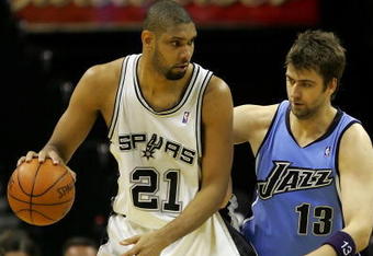 SAN ANTONIO - MAY 20:  Tim Duncan #21 of the San Antonio Spurs posts up Mehmet Okur #13 of the Utah Jazz in the third quarter of Game One of the Western Conference Finals during the 2007 NBA Playoffs at AT&T Center on May 20, 2007 in San Antonio, Texas. NOTE TO USER: User expressly acknowledges and agrees that, by downloading and or using this photograph, User is consenting to the terms and conditions of the Getty Images License Agreement.  (Photo by Lisa Blumenfeld/Getty Images)