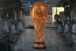 BEIJING, CHINA - JUNE 5: (CHINA OUT) An attendant is seen through a show window featuring football stars and the World Cup trophy at an adidas shop on June 5, 2006 in Beijing, China. Billboards and decorations featuring imagery relating to the World Cup, which starts June 9 in Germany, are being displayed on many Beijing streets as the event is seen as a great opportunity for local businesses, according to local media. (Photo by China Photos/Getty Images)