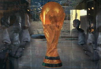 BEIJING, CHINA - JUNE 5: (CHINA OUT) An attendant is seen through a show window featuring football stars and the World Cup trophy at an adidas shop on June 5, 2006 in Beijing, China. Billboards and decorations featuring imagery relating to the World Cup, which starts June 9 in Germany, are being displayed on many Beijing streets as the event is seen as a great opportunity for local businesses, according to local media. (Photo by China Photos/Getty Images)
