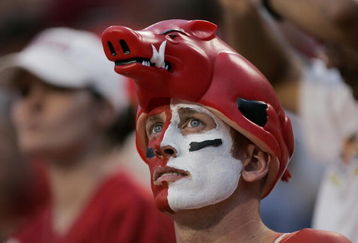 FAYETTEVILLE, AR - SEPTEMBER 2:  A male fan of the Arkansas Razorbacks looks on wearing face paint and a hog hat during the game against the University of Southern California Trojans on September 2, 2006 at Donald W. Reynolds Razorback Stadium in Fayetteville, Arkansas.  Southern California won 50-14.  (Photo by Brian Bahr/Getty Images)