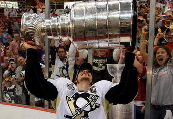 DETROIT - JUNE 12:  Sidney Crosby #87 of the Pittsburgh Penguins celebrates with the Stanley Cup after defeating the Detroit Red Wings by a score of 2-1 to win Game Seven and the 2009 NHL Stanley Cup Finals at Joe Louis Arena on June 12, 2009 in Detroit, Michigan.  (Photo by Jim McIsaac/Getty Images)