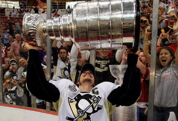 DETROIT - JUNE 12:  Sidney Crosby #87 of the Pittsburgh Penguins celebrates with the Stanley Cup after defeating the Detroit Red Wings by a score of 2-1 to win Game Seven and the 2009 NHL Stanley Cup Finals at Joe Louis Arena on June 12, 2009 in Detroit, Michigan.  (Photo by Jim McIsaac/Getty Images)