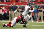 ATLANTA - OCTOBER 12:  Desmond Clark #88 of the Chicago Bears carries the ball against Curtis Lofton #50 of the Atlanta Falcons at the Georgia Dome on October 12, 2008 in Atlanta, Georgia.  (Photo by Kevin C. Cox/Getty Images)