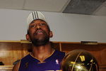 ORLANDO, FL - JUNE 14:  DJ Mbenga #28 of the Los Angeles Lakers holds the Larry O'Brien trophy in the locker room after the Lakers defeated the Orlando Magic 99-86 in Game Five of the 2009 NBA Finals on June 14, 2009 at Amway Arena in Orlando, Florida.  NOTE TO USER:  User expressly acknowledges and agrees that, by downloading and or using this photograph, User is consenting to the terms and conditions of the Getty Images License Agreement.  (Photo by Ronald Martinez/Getty Images)