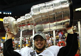 DETROIT - JUNE 12:  Tyler Kennedy #48 of the Pittsburgh Penguins celebrates with the Stanley Cup after defeating the Detroit Red Wings by a score of 2-1 to win Game Seven and the 2009 NHL Stanley Cup Finals at Joe Louis Arena on June 12, 2009 in Detroit, Michigan.  (Photo by Jim McIsaac/Getty Images)