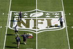 TAMPA, FL - JANUARY 31:  Workers paint the NFL logo on center field a day before Super Bowl XLIII between the Arizona Cardinals and the Pittsburgh Steelers on January 31, 2009 at Raymond James Stadium in Tampa, Florida.  (Photo by Win McNamee/Getty Images)