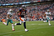 DENVER - NOVEMBER 02:  Wide receiver Brandon Marshall #15 of the Denver Broncos makes a reception and eludes the defense of Jason Allen #32 and Tyrone Culver #29 of the Miami Dolphins before being nulified by a penalty during NFL action at Invesco Field at Mile High on November 2, 2008 in Denver, Colorado. The Dolphins defeated the Broncos 26-17.  (Photo by Doug Pensinger/Getty Images)