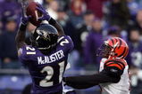 BALTIMORE - NOVEMBER 05:  Chris McAlister #21 of the Baltimore Ravens makes an interception in front of Chris Henry #15 of the Cincinnati Bengals to preserve a 26-20 Ravens win during the fourth quarter on November 5, 2006 at M&T Bank Stadium in Baltimore, Maryland.  (Photo by Harry How/Getty Images)