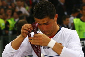 ROME - MAY 27:  Cristiano Ronaldo of Manchester United takes of his medal after Manchester United lost the UEFA Champions League Final match between Barcelona and Manchester United at the Stadio Olimpico on May 27, 2009 in Rome, Italy. Barcelona won 2-0.  (Photo by Alex Livesey/Getty Images)