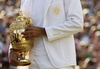LONDON - JULY 08:  Roger Federer of Switzerland holds the trophy as he celebrates victory following the Men's Singles final match against Rafael Nadal of Spain during day thirteen of the Wimbledon Lawn Tennis Championships at the All England Lawn Tennis and Croquet Club on July 8, 2007 in London, England. Roger Federer claims his fifth consecutive championship title.  (Photo by Clive Brunskill/Getty Images)