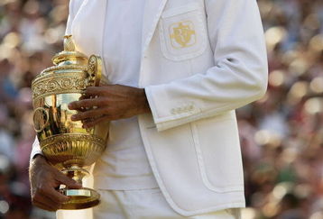 LONDON - JULY 08:  Roger Federer of Switzerland holds the trophy as he celebrates victory following the Men's Singles final match against Rafael Nadal of Spain during day thirteen of the Wimbledon Lawn Tennis Championships at the All England Lawn Tennis and Croquet Club on July 8, 2007 in London, England. Roger Federer claims his fifth consecutive championship title.  (Photo by Clive Brunskill/Getty Images)