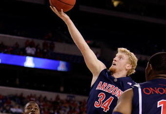INDIANAPOLIS - MARCH 27:  Chase Budinger #34 of the Arizona Wildcats drives for a shot attempt against the Louisville Cardinals  during the third round of the NCAA Division I Men's Basketball Tournament at the Lucas Oil Stadium on March 27, 2009 in Indianapolis, Indiana.  (Photo by Andy Lyons/Getty Images)