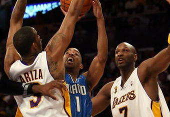 LOS ANGELES, CA - JUNE 07:  Rafer Alston #1 of the Orlando Magic goes up for a shot between Trevor Ariza #3 and Lamar Odom #7 of the Los Angeles Lakers in the first quarter of Game Two of the 2009 NBA Finals at Staples Center on June 7, 2009 in Los Angeles, California. NOTE TO USER: User expressly acknowledges and agrees that, by downloading and or using this photograph, User is consenting to the terms and conditions of the Getty Images License Agreement.  (Photo by Jed Jacobsohn/Getty Images)