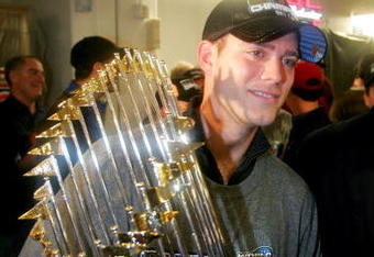 ST LOUIS - OCTOBER 27:  General manager Theo Epstein of the Boston Red Sox celebrates in the locker room with the Championship trophy after defeating the St. Louis Cardinals 3-0 in game four of the World Series on October 27, 2004 at Busch Stadium in St. Louis, Missouri.  (Photo by Ezra Shaw/Getty Images)