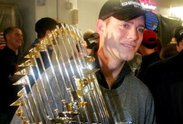 ST LOUIS - OCTOBER 27:  General manager Theo Epstein of the Boston Red Sox celebrates in the locker room with the Championship trophy after defeating the St. Louis Cardinals 3-0 in game four of the World Series on October 27, 2004 at Busch Stadium in St. Louis, Missouri.  (Photo by Ezra Shaw/Getty Images)