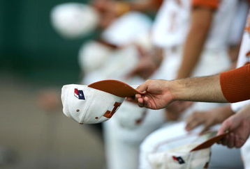 OMAHA, NE - JUNE 22:  Members of the Texas Longhorns shake 'rally caps' against the Baylor Bears during game 12 of the 59th College World Series on June 22, 2005 at Rosenblatt Stadium in Omaha, Nebraska.  (Photo by Jed Jacobsohn/Getty Images)