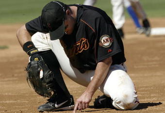 SCOTTSDALE, AZ - MARCH 8:  First baseman J.T. Snow #6 of the San Francisco Giants takes a moment to recover after diving unsuccesffully for a line drive against the Kansas City Royals during their spring training game on March 8, 2004 at Scottsdale Stadium in Scottsdale, Arizona.  (Photo by Stephen Dunn/Getty Images)