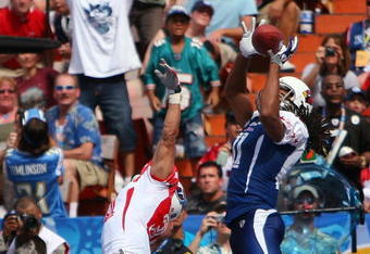 HONOLULU, HI - FEBRUARY 08: Wide receiver Larry Fitzgerald #11 of the NFC All-Stars Arizona Cardinals leaps and catches a 2 yard touchdown pass while covered by cornerback Cortland Finnegan #31 of the AFC All-Stars Tennessee Titans in the 2009 NFL Pro Bowl at Aloha Stadium on February 8, 2009 in Honolulu, Hawaii. The NFC defeated the AFC 30-21. (Photo by Paul Spinelli/Getty Images)