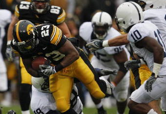 IOWA CITY, IOWA - NOVEMBER 8: Shonn Greene #23 of the Iowa Hawkeyes rushes for yards as Philip Welch #18 of the Penn State Nittany Lions tackles him as his teammates Lydell Sargeant #10 and Mark Rubin #9 watch on in the third quarter of play at Kinnick Stadium on November 8, 2008 in Iowa City, Iowa. Iowa defeated Penn State  24-23. (Photo by David Purdy/Getty Images)