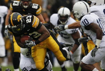 IOWA CITY, IOWA - NOVEMBER 8: Shonn Greene #23 of the Iowa Hawkeyes rushes for yards as Philip Welch #18 of the Penn State Nittany Lions tackles him as his teammates Lydell Sargeant #10 and Mark Rubin #9 watch on in the third quarter of play at Kinnick Stadium on November 8, 2008 in Iowa City, Iowa. Iowa defeated Penn State  24-23. (Photo by David Purdy/Getty Images)