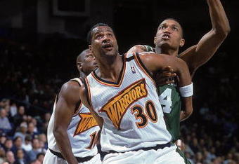 18 Feb 2000: Billy Owens #30 of the Golden State Warriors guards Tony Battie #4 of the Boston Celtics at the Oakland Coliseum in Oakland, California. The Warriors defeated the Celtics 122-100.    Mandatory Credit: Jed Jacobsohn  /Allsport