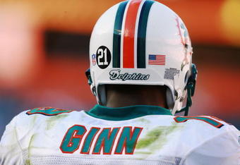 MIAMI - DECEMBER 02: Wide receiver Ted Ginn Jr. #19 of the Miami Dolphins stands on the sideline with a #21 on his helmet in memory of slain Washington Redskins player Sean Taylor, as they take on the New York Jets at Dolphin Stadium on December 2, 2007 in Miami, Florida. The Jets defeated the Dolphins 40-13.  (Photo by Doug Benc/Getty Images)