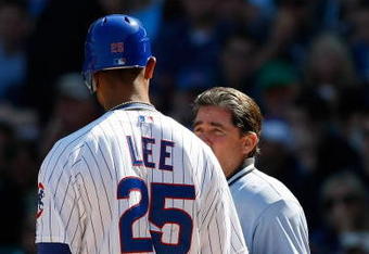 CHICAGO, IL - SEPTEMBER 18: First baseman Derrek Lee #25  of the Chicago Cubs argues with home plate umpire Ed Rapuano #19 after a called strike against the Milwaukee Brewers at the Wrigley Field on September 18, 2008 in Chicago, Illinois. (Photo by Scott Boehm/Getty Images)
