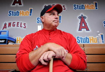 ANAHEIM, CA - APRIL 10:  Mike Scioscia #14 manager of the Los Angeles Angels reflects on pitcher Nick Adenhart's death as he answers questions in the dugout at Angel Stadium April 10, 2009 in Anaheim, California. Adenhart and two others were killed in car crash on April 9.  (Photo by Kevork Djansezian/Getty Images)