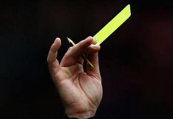MIDDLESBROUGH, ENGLAND - APRIL 11:  Referee Phil Dowd awards a yellow card to Andrew Taylor of Middlesbrough during the Barclays Premier League match between Middlesbrough and Hull City at the Riverside Stadium on April 11, 2009 in Middlesbrough, England  (Photo by Matthew Lewis/Getty Images)