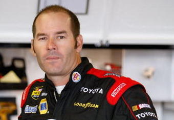 WATKINS GLEN, NY - AUGUST 10:  P.J. Jones, driver of the #00 Burger King Toyota, stands in the garage area prior to practice for the NASCAR Nextel Cup Series Centurion Boats at The Glen at Watkins Glen International on August 10, 2007 in Watkins Glen, New York.  (Photo by John Harrelson/Getty Images for NASCAR)