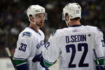 ANAHEIM, CA - MARCH 11:  Henrik Sedin #33 of the Vancouver Canucks has a word with teammate and brother Daniel Sedin #22 during a break in NHL game action against the Anaheim Ducks at Honda Center on March 11, 2009 in Anaheim, California. The Ducks defeated the Canucks 4-3 in overtime.  (Photo by Victor Decolongon/Getty Images)