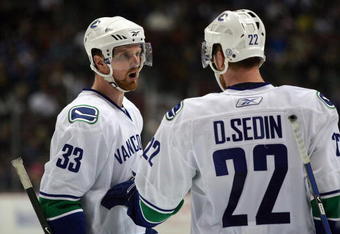 ANAHEIM, CA - MARCH 11:  Henrik Sedin #33 of the Vancouver Canucks has a word with teammate and brother Daniel Sedin #22 during a break in NHL game action against the Anaheim Ducks at Honda Center on March 11, 2009 in Anaheim, California. The Ducks defeated the Canucks 4-3 in overtime.  (Photo by Victor Decolongon/Getty Images)