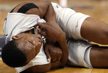 HARTFORD, CT - FEBRUARY 16:  Hasheem Thabeet #34 of the Connecticut Huskies grimaces in pain after he and DeJuan Blair #45 of the Pittsburgh Panthers collided going after a rebound on February 16, 2009 at XL Center  in Hartford, Connecticut. Thabeet was thrown to the ground on the play.  (Photo by Elsa/Getty Images)