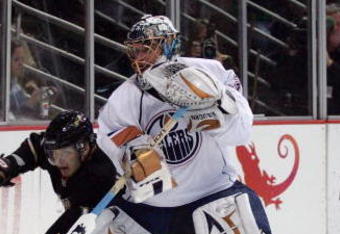 ANAHEIM, CA - MARCH 27:  Petteri Nokelainen #17 of the Anaheim Ducks pursues the puck after being played along the boards by goaltender Dwayn Roloson #35 of the Edmonton Oilers during the NHL game at Honda Center on March 27, 2009 in Anaheim, California. The Oilers defeated the Ducks 5-3. (Photo by Victor Decolongon/Getty Images)