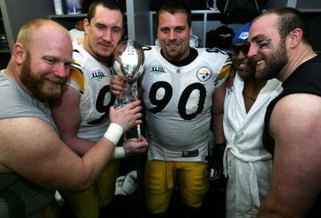 TAMPA, FL - FEBRUARY 01:  (L-R) Chris Hoke #76, Aaron Smith #91 Travis Kirschke #90,  Casey Hampton #98 and Brett Keisel #99 of the Pittsburgh Steelers celebrates with the Vince Lombardi trophy in the locker room after defeating the Arizona Cardinals during Super Bowl XLIII on February 1, 2009 at Raymond James Stadium in Tampa, Florida. The Steelers won the game by a score of 27-23.  (Photo by Al Bello/Getty Images)